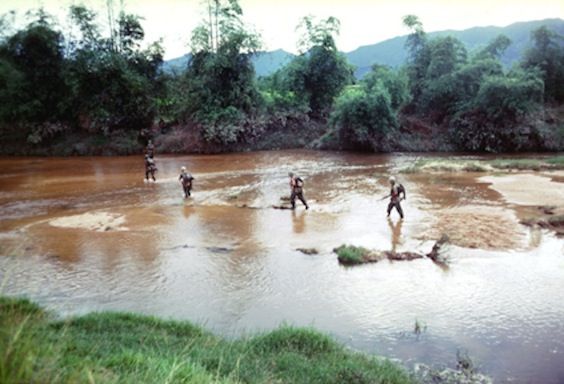 Marines crossing a river
